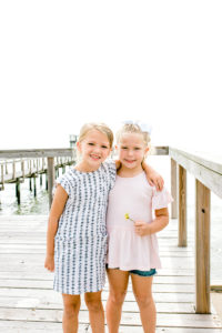 Sisters Standing on the Dock in the Summer Heat